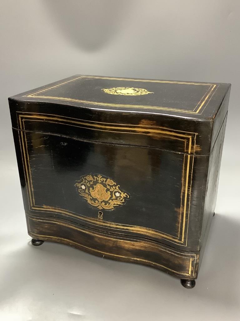 A French ebonised decanter case, c.1870, hinged lid opening to reveal four liqueur decanters and stoppers together with sixteen liqueur glasses, height 28cm